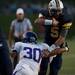 Saline senior quarterback Tyler Palka is tackled by Pioneer senior linebacker Michael Sherman on Friday. Daniel Brenner I AnnArbor.com